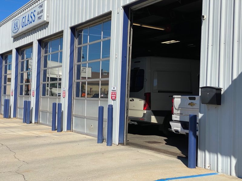 A service bay at A&A Glass with a van and a Silverado truck pulled inside
