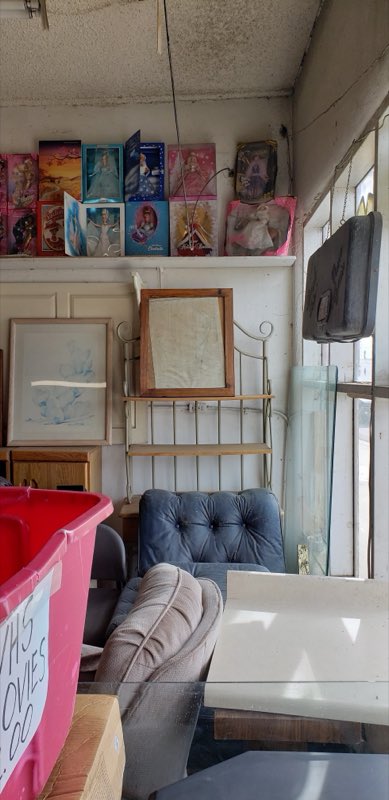 Interior shelves with framed art, collectible dolls, furniture and household goods