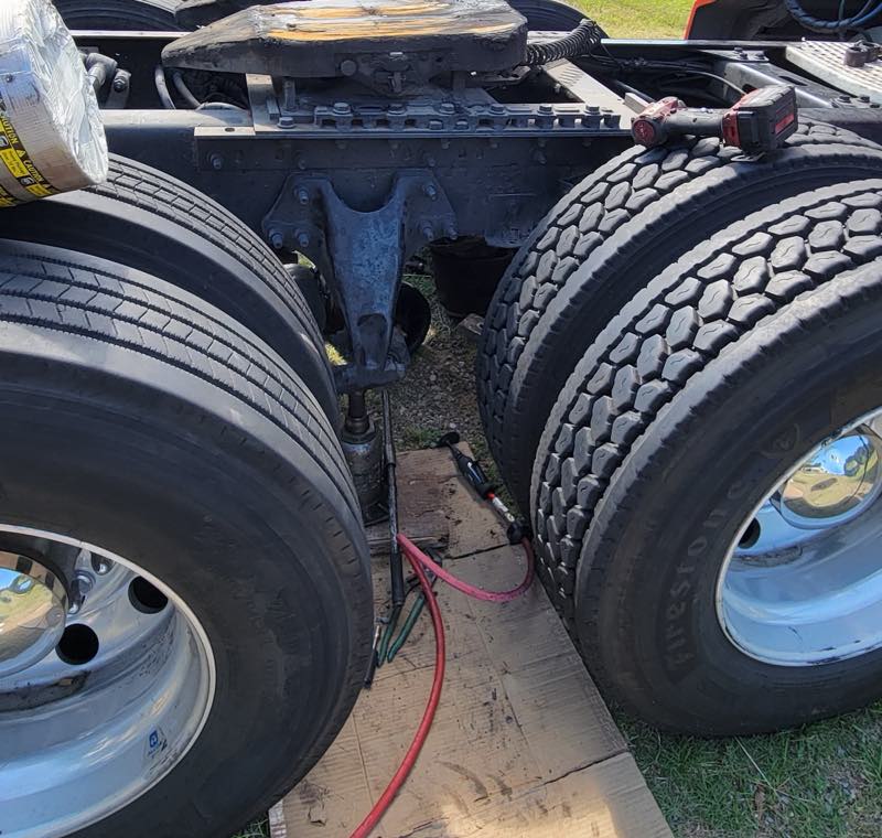 Rear driveline and dual wheels of a semi truck being serviced