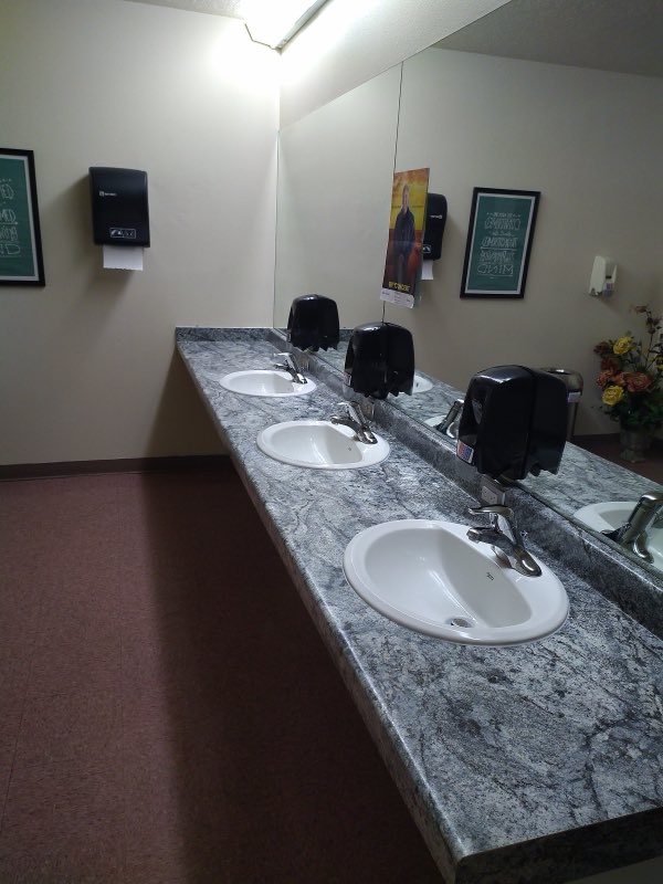 Commercial restroom with granite double vanity