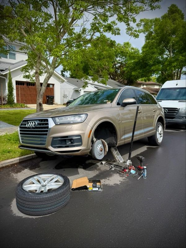 Mobile brake and tire job on an Audi Q7 curbside