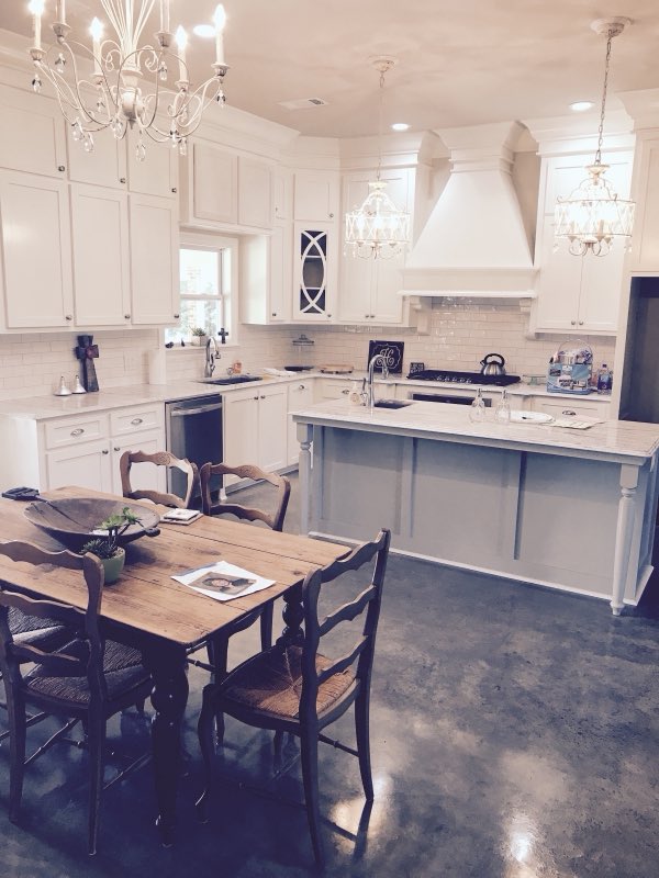 White farmhouse kitchen with a decorative stained concrete floor