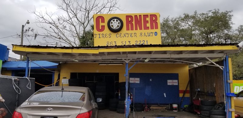 Corner Tires Center and Auto storefront with cars being serviced