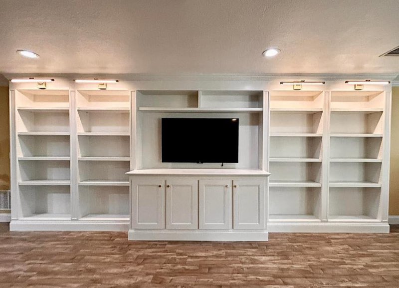 Large white built-in entertainment center and bookshelves