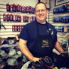 Owner Bryan smiling behind the workbench