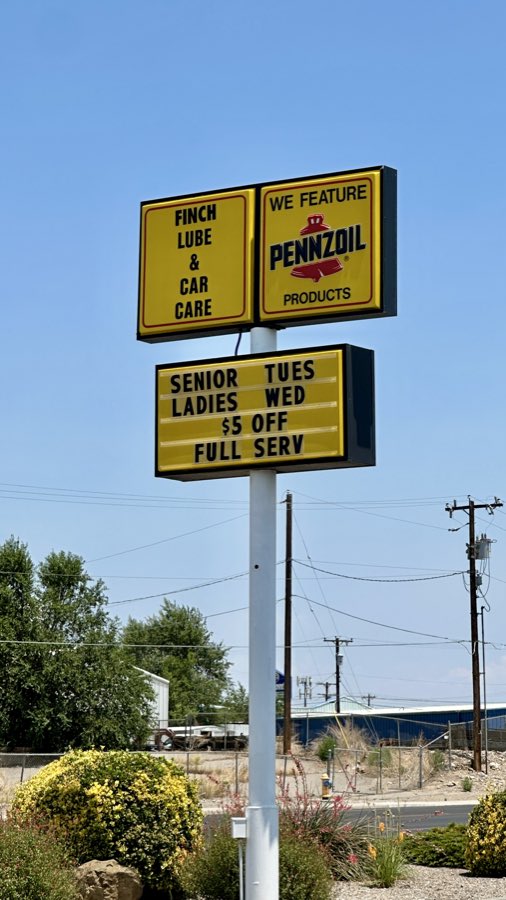 Finch Lube & Car Care's tall yellow roadside sign and marquee on San Juan Blvd.
