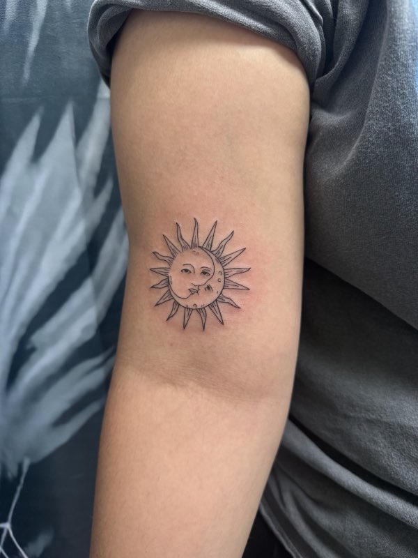 Fine-line sun tattoo on upper arm (owner-posted)