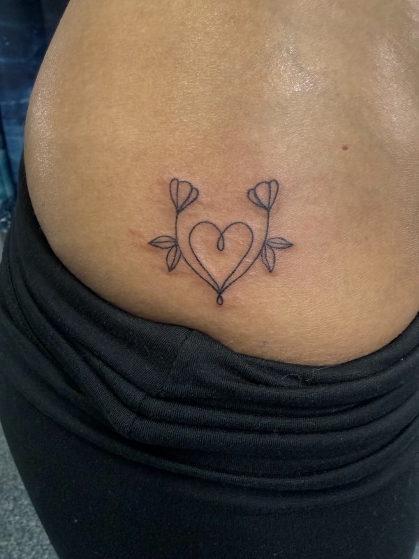 Small heart-and-flowers hip tattoo (owner-posted)