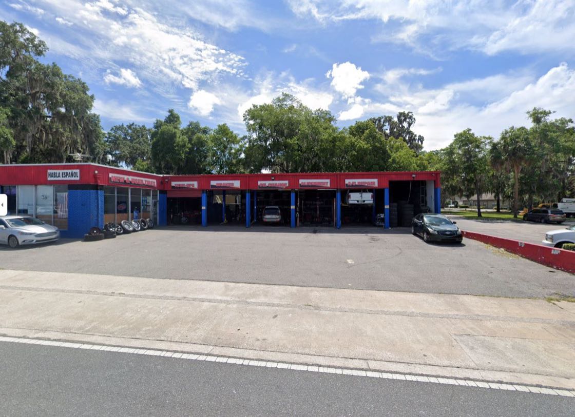 Florida Tires storefront on S Pine Ave with open service bays and blue sky