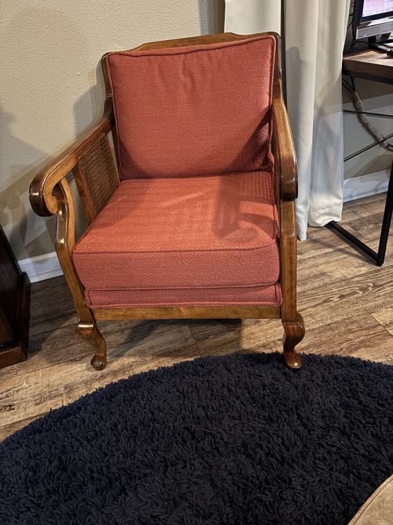 Cane-side wooden armchair with new coral cushions