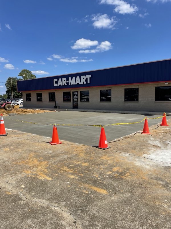 Freshly poured commercial parking lot in front of a Car-Mart store