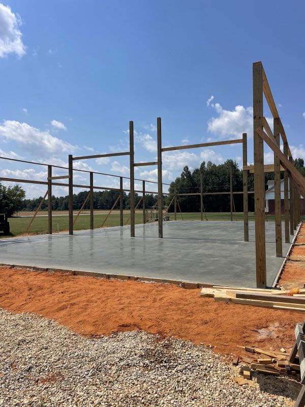 Commercial foundation slab with a building frame being raised on top