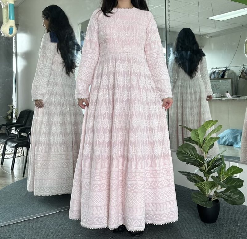 Client in a full blush lace gown seen front and back in the shop mirrors