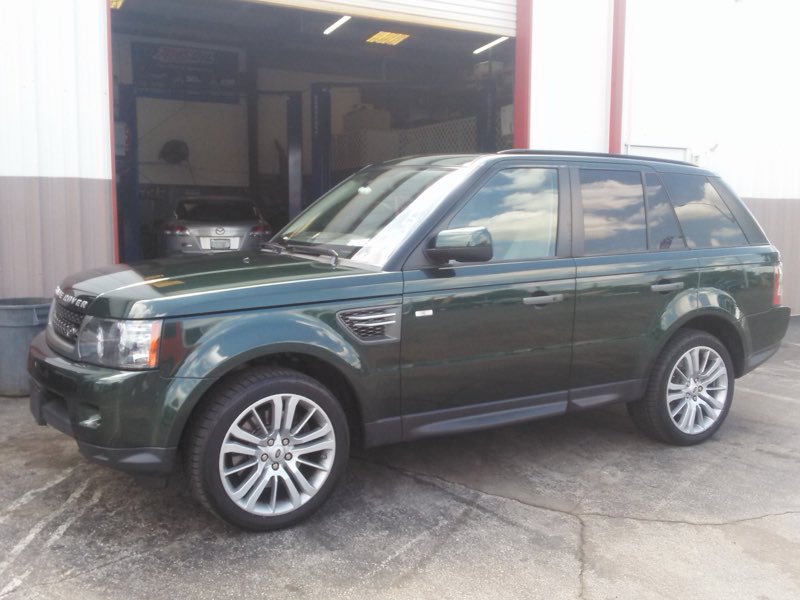 Range Rover at the open service bay door of Ideal Service Center