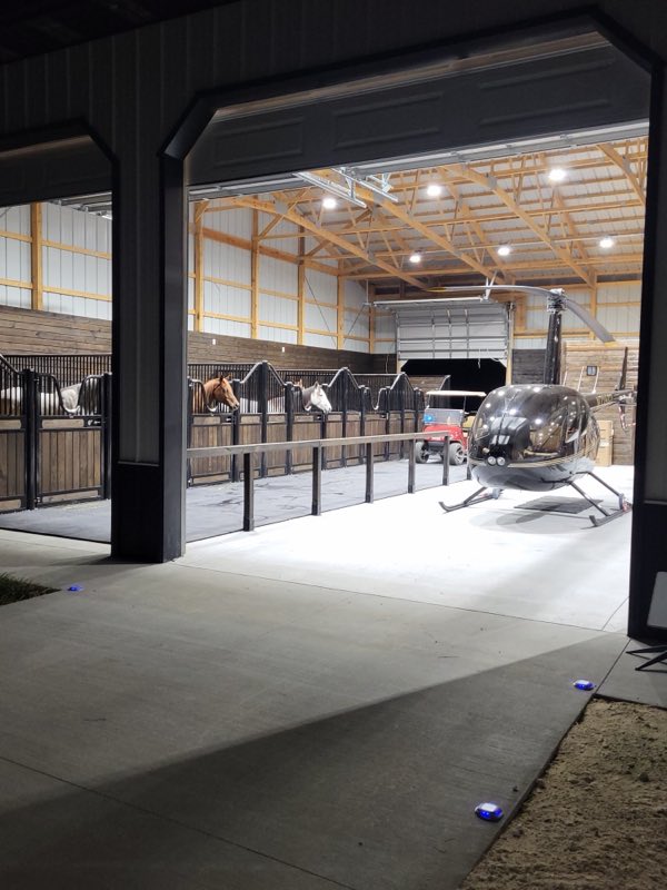 Finished barn interior with new lighting, horse stalls and a hangar