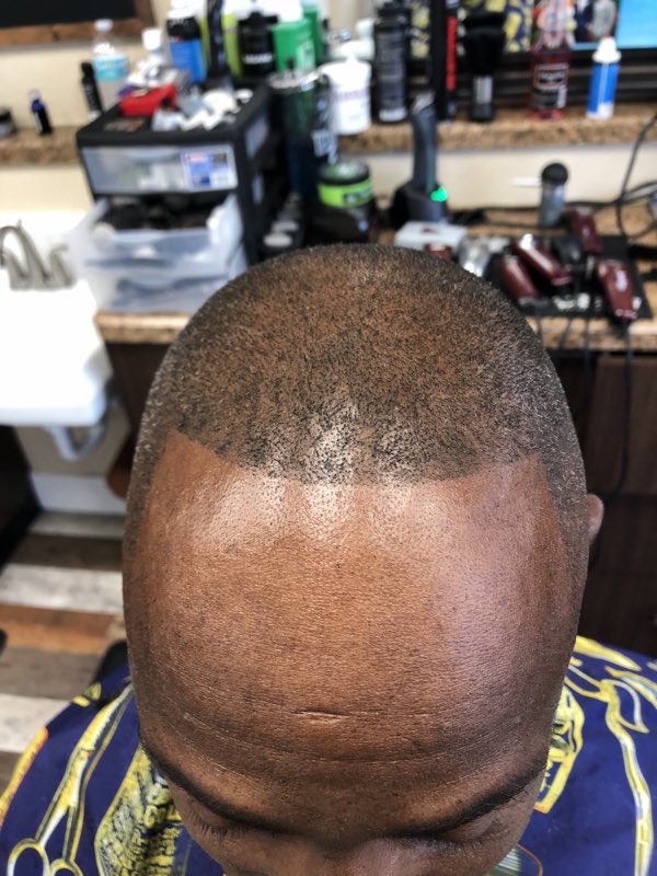 Work sample - a crisp skin fade with a sharp lineup, seen from above the chair