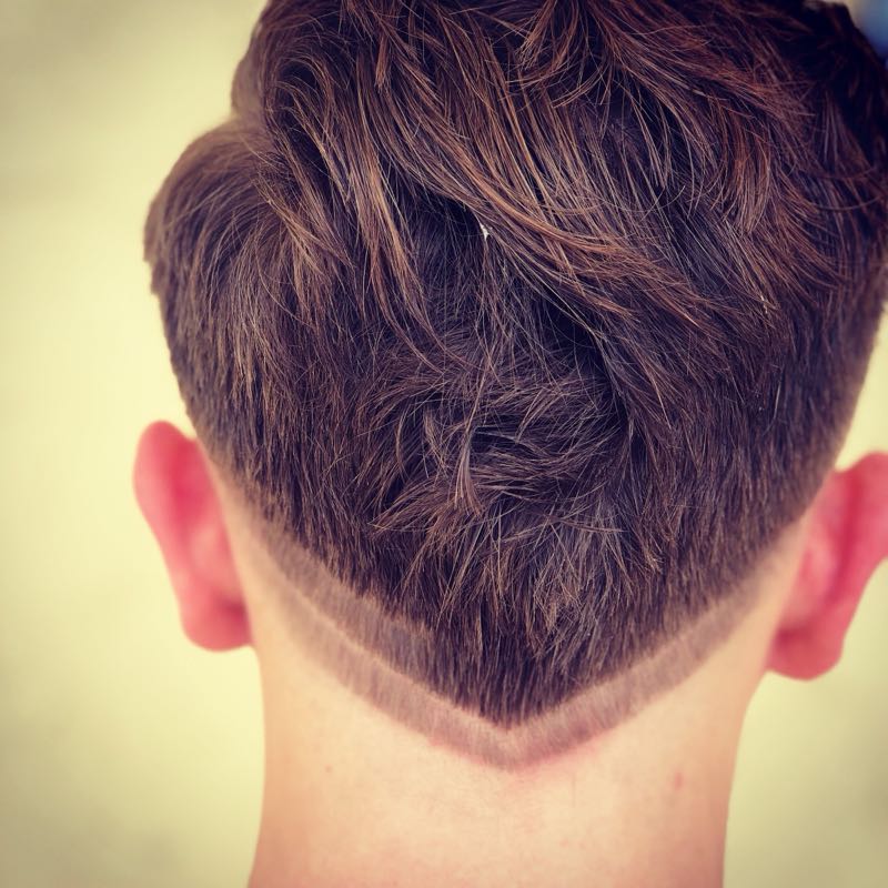 Work sample - the back of a textured haircut with a sharp taper and clean V-shaped neckline