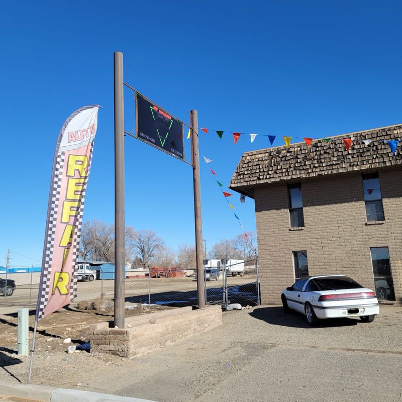 AUTO REPAIR feather flag and the Mr. Richard's Speed Shop sign at the entrance