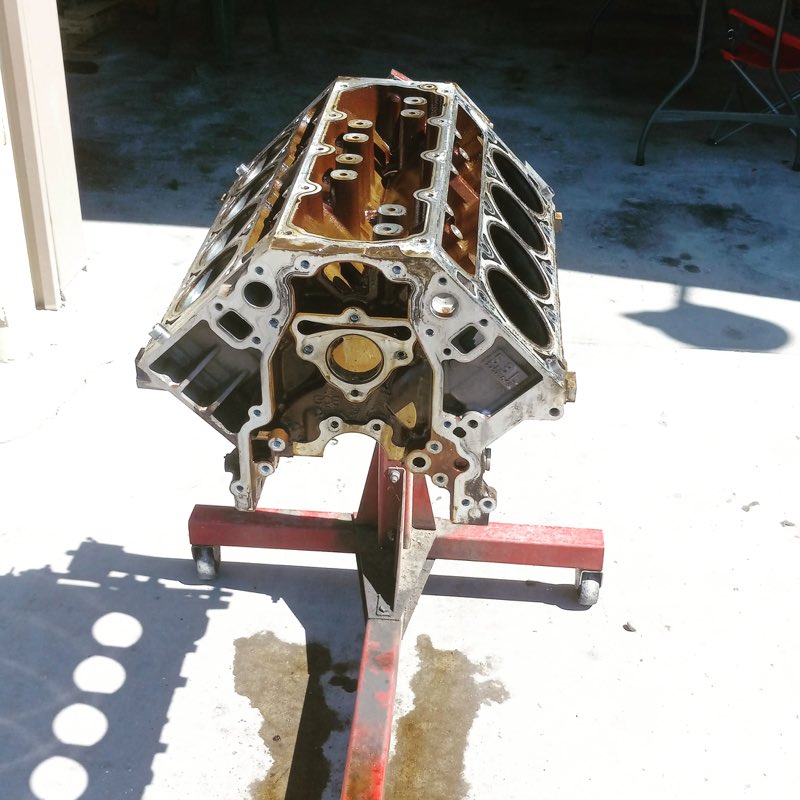 Bare engine block mounted on a stand for machine work