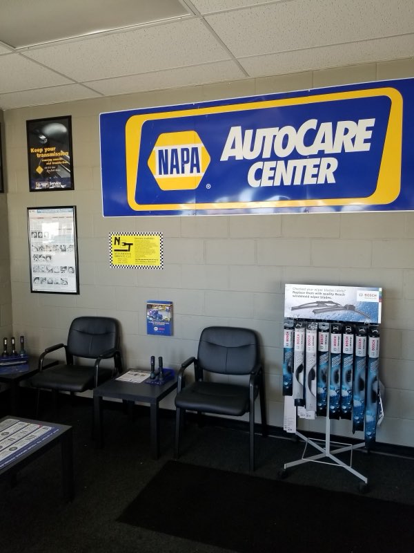 Customer waiting area beneath a NAPA AutoCare Center banner