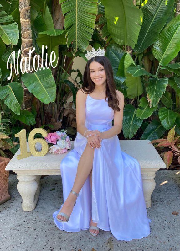 Sweet-sixteen client seated outdoors in a lavender satin gown altered by NYC Alterations