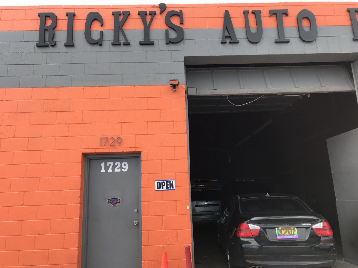 Ricky's Auto orange storefront in Farmington with the OPEN sign out