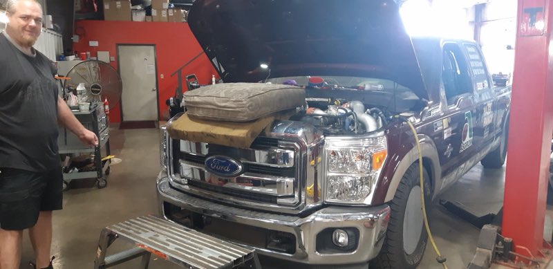 Technician working on a Ford Super Duty on the lift