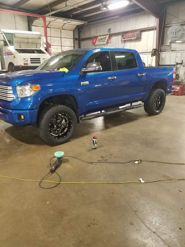 Lifted blue Toyota Tundra in the shop