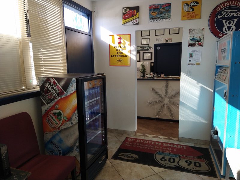 TC Automotive waiting room with a Route 66 rug, cold drinks and vintage Ford memorabilia