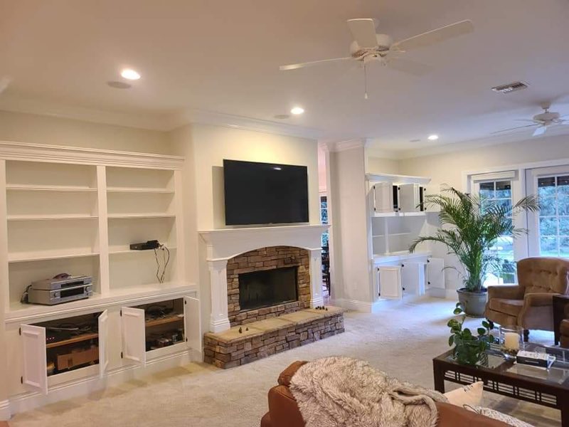 Interior living room with white built-ins, fireplace and crisp trim