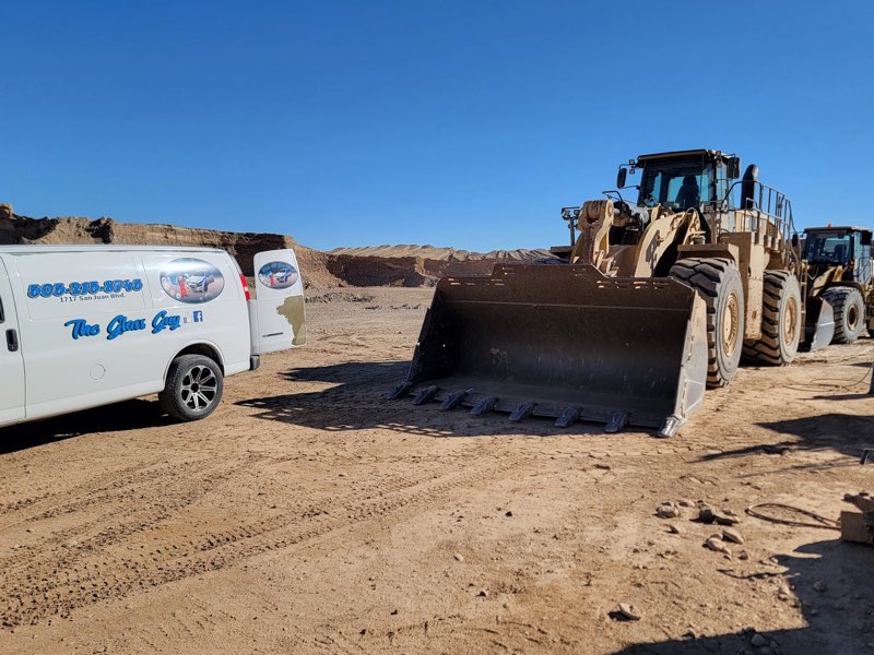 The Glass Guy mobile service van on-site next to heavy equipment